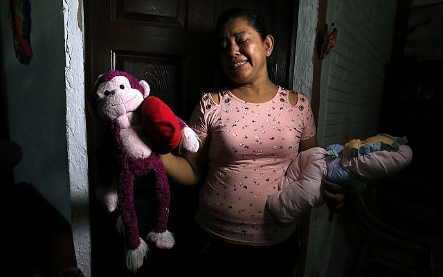 Rosa Ramirez sobs as she shows journalists toys that belonged to her nearly 2-year-old granddaughter Valeria in her home in San Martin, El Salvador, Tuesday, June 25, 2019. The drowned bodies of Ramirez's son, 25-year-old Oscar Alberto Martinez Ramirez, and his daughter were located Monday morning on the banks of the Rio Grande, a day after the pair were swept away by the current when the young family tried to cross the river to Brownsville, Texas. Her daughter-in-law Tania Vanessa Avalos, 21, survived. (AP Photo/Antonio Valladares)