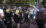 After a confrontation between authorities and protesters, police use pepper spray as multiple groups, including Rose City Antifa, the Proud Boys and others protest in downtown Portland, Oregon on Saturday, June 29, 2019. (Dave Killen/The Oregonian/AP)
