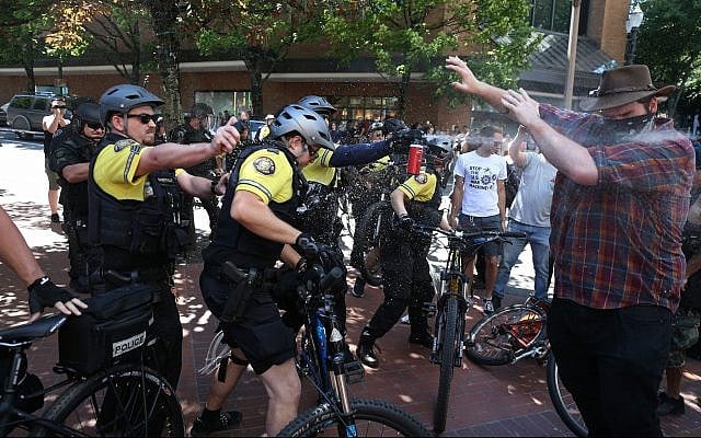 After a confrontation between authorities and protesters, police use pepper spray as multiple groups, including Rose City Antifa, the Proud Boys and others protest in downtown Portland, Oregon on Saturday, June 29, 2019. (Dave Killen/The Oregonian/AP) After a confrontation between authorities and protesters, police use pepper spray as multiple groups, including Rose City Antifa, the Proud Boys and others protest in downtown Portland, Oregon on Saturday, June 29, 2019. (Dave Killen/The Oregonian/AP)