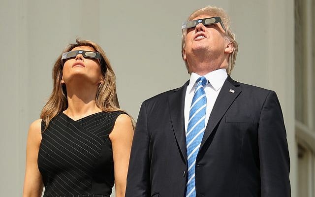 President Donald Trump, accompanied by first lady Melania Trump, holds up protective glasses as they arrive to view the solar eclipse, Monday, Aug. 21, 2017, at the White House in Washington. (AP Photo/Andrew Harnik) President Donald Trump, accompanied by first lady Melania Trump, holds up protective glasses as they arrive to view the solar eclipse, Monday, Aug. 21, 2017, at the White House in Washington. (AP Photo/Andrew Harnik)