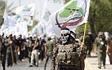 In this illustrative photo from July 1, 2016, members of the Iran-backed Asaib Ahl al-Haq paramilitary group take part in a Quds Day march in Baghdad, Iraq. (AP Photo/Hadi Mizban, File)