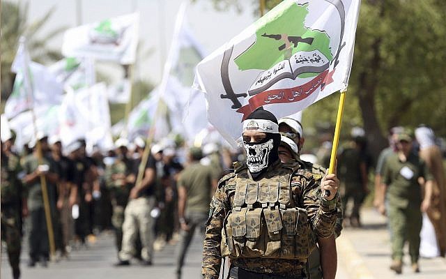 In this illustrative photo from July 1, 2016, members of the Iran-backed Asaib Ahl al-Haq paramilitary group take part in a Quds Day march in Baghdad, Iraq. (AP Photo/Hadi Mizban, File) In this illustrative photo from July 1, 2016, members of the Iran-backed Asaib Ahl al-Haq paramilitary group take part in a Quds Day march in Baghdad, Iraq. (AP Photo/Hadi Mizban, File)