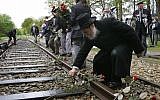 Illustrative: In this photo from May 9, 2015, a man puts a rose on the railroad tracks at former concentration camp Westerbork, the Netherlands, remembering more than a hundred thousand Jews who were transported from Westerbork to Nazi death camps. (AP Photo/Peter Dejong)