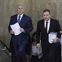 Prime Minister Benjamin Netanyahu, left, and Prime Minister's Office Director-General Yoav Horowitz, right, arrive for a weekly cabinet meeting at the Prime Minister's Office in Jerusalem, December 16, 2018. (Abir Sultan/Pool Photo via AP)