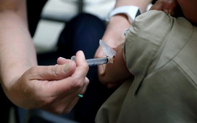 In this Friday, May 17, 2019 photo, Starr Roden, left, a registered nurse and immunization outreach coordinator with the Knox County Health Department, administers a vaccination to Jonathan Detweiler, 6, at the facility in Mount Vernon, Ohio. (AP Photo/Paul Vernon) In this Friday, May 17, 2019 photo, Starr Roden, left, a registered nurse and immunization outreach coordinator with the Knox County Health Department, administers a vaccination to Jonathan Detweiler, 6, at the facility in Mount Vernon, Ohio. (AP Photo/Paul Vernon)