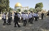 Police officers escort a group of religious Jews at the Temple Mount compound in Jerusalem's Old City, June 2, 2019. (AP Photo/Mahmoud Illean)