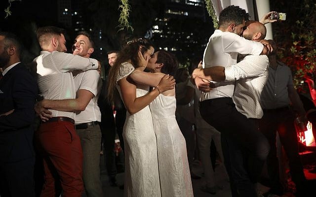 Gay couples take part in a mass same-sex wedding in Tel Aviv, Israel, Tuesday, June 4, 2019 (AP Photo/Oded Balilty)
