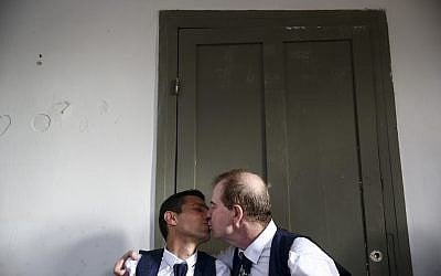 Gay couple kisses during a mass same-sex wedding in Tel Aviv, Israel, Tuesday, June 4, 2019 (AP Photo/Oded Balilty)