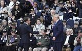 US President Donald Trump, right, and French President Emmanuel Macron reach out to shake hands during a ceremony to mark the 75th anniversary of D-Day at the Normandy American Cemetery in Colleville-sur-Mer, Normandy, France, June 6, 2019. (AP/David Vincent)