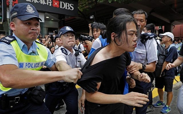 A protester is taken by police officers as protesters march against the proposed amendments to an extradition law in Hong Kong, June 9, 2019 (AP Photo/Vincent Yu)