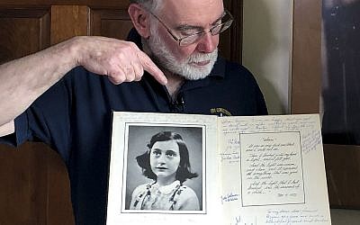 Ryan Cooper holds a 1972 portion of a diary that he wrote when he visited Otto Frank, the father of the famed Holocaust victim and diarist Anne Frank, at his home, on June 7, 2019. (AP Photo/Philip Marcelo)