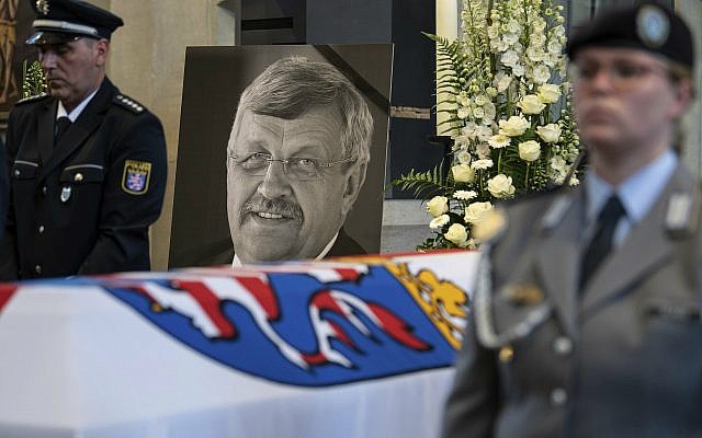 In this June 13, 2019 file photo a picture of Walter Luebcke stands behind his coffin during the funeral service in Kassel, Germany. (Swen Pfoertner/dpa via AP) In this June 13, 2019 file photo a picture of Walter Luebcke stands behind his coffin during the funeral service in Kassel, Germany. (Swen Pfoertner/dpa via AP)