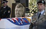 In this June 13, 2019 file photo a picture of Walter Luebcke stands behind his coffin during the funeral service in Kassel, Germany. (Swen Pfoertner/dpa via AP)