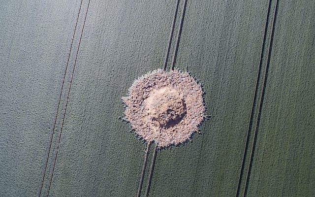 A big crater is pictured on a corn field after a bomb from World War II exploded in Halbach, Germany, June 24, 2019. (Boris Roessler/dpa via AP)