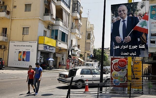 In this June 24, 2019 photo, a poster shows George Aoun, head of the municipality of the village of Hadat, with Arabic that reads 'We are all George Edward Aoun. Hadat youth,' in the Christian village of Hadat, where only Christians can rent or buy property, near Beirut, Lebanon (AP Photo/Bilal Hussein) In this June 24, 2019 photo, a poster shows George Aoun, head of the municipality of the village of Hadat, with Arabic that reads 'We are all George Edward Aoun. Hadat youth,' in the Christian village of Hadat, where only Christians can rent or buy property, near Beirut, Lebanon (AP Photo/Bilal Hussein)