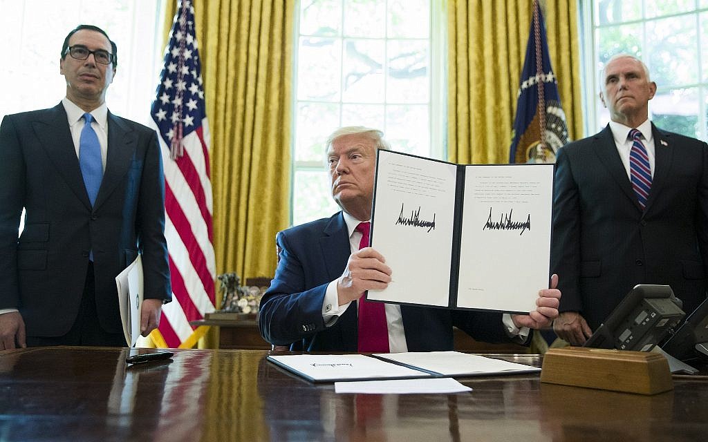 Then-US president Donald Trump holds up a signed executive order to increase sanctions on Iran, in the Oval Office of the White House, June 24, 2019, in Washington. Trump is accompanied by then-treasury secretary Steve Mnuchin, left, and then-vice president Mike Pence. (AP Photo/Alex Brandon) Then-US president Donald Trump holds up a signed executive order to increase sanctions on Iran, in the Oval Office of the White House, June 24, 2019, in Washington. Trump is accompanied by then-treasury secretary Steve Mnuchin, left, and then-vice president Mike Pence. (AP Photo/Alex Brandon)