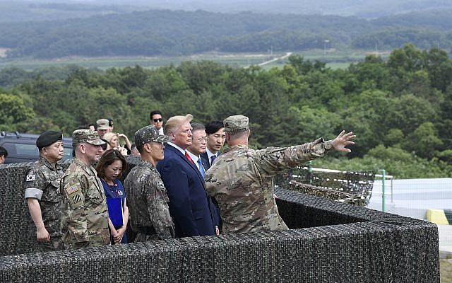 US President Donald Trump views North Korea from the Korean Demilitarized Zone from Observation Post Ouellette at Camp Bonifas in South Korea, June 30, 2019. (AP Photo/Susan Walsh) US President Donald Trump views North Korea from the Korean Demilitarized Zone from Observation Post Ouellette at Camp Bonifas in South Korea, June 30, 2019. (AP Photo/Susan Walsh)