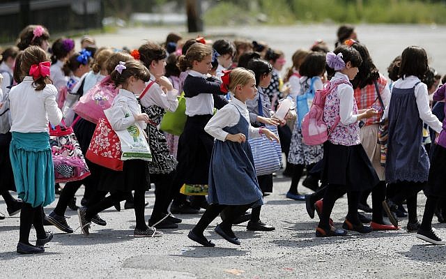 Illustrative: Girls walk to waiting buses after summer day camp on July 1, 2014, in Kiryas Joel, New York (AP Photo/Mike Groll) Illustrative: Girls walk to waiting buses after summer day camp on July 1, 2014, in Kiryas Joel, New York (AP Photo/Mike Groll)