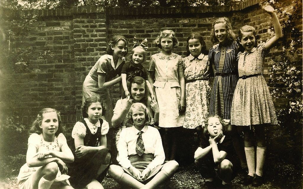 In Arnhem on May 8, 1942, four days after her Uncle Otto’s arrest, Audrey Hepburn (standing, left) holds Annelies Bouma at a birthday party for sister Hilda (striped dress), who is Audrey’s classmate from the Middelbare Meisjes School and dance mate at ballet school. A third Bouma sister, Maya, sticks out her tongue at the camera. (Van Rossem-Bouma Family Collection)
