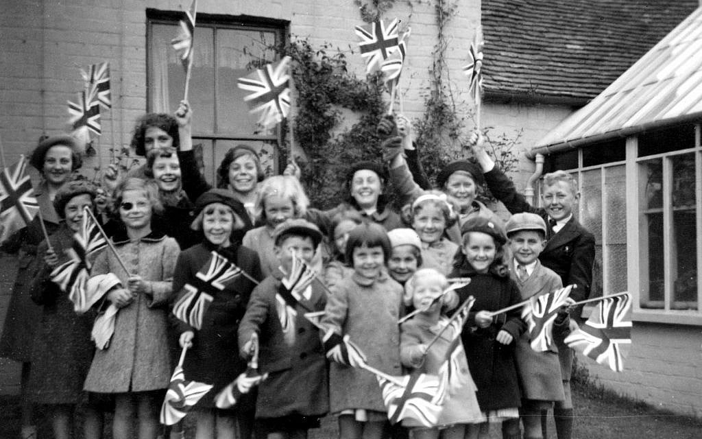 Near the end of her stay in Elham, Audrey Hepburn (fourth from left) waves the Union Jack. (Dotti Collection)