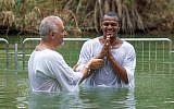 Houston Texans all-star quarterback Deshaun Watson (right) getting baptized in the Jordan River, June 19, 2019. (American Voices in Israel)