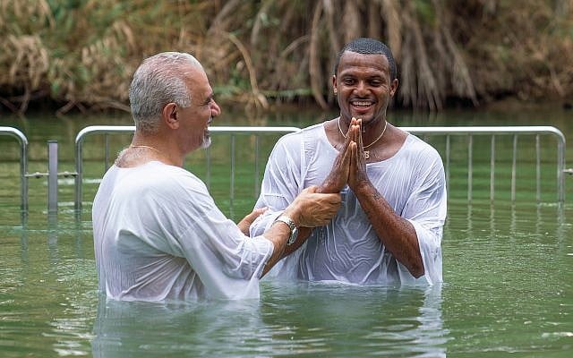 Houston Texans all-star quarterback Deshaun Watson (right) getting baptized in the Jordan River, June 19, 2019. (American Voices in Israel) Houston Texans all-star quarterback Deshaun Watson (right) getting baptized in the Jordan River, June 19, 2019. (American Voices in Israel)