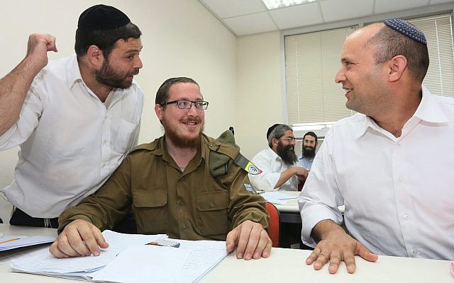 Then-economics minister Naftali Bennett visits a center in the central Israeli city of Bnei Brak where religious men and women are trained in math, English and other core subjects not taught in ultra-Orthodox schools and seminaries, on April 2015, 2013. (Assaf Shilo/Economy Minister/Flash90) Then-economics minister Naftali Bennett visits a center in the central Israeli city of Bnei Brak where religious men and women are trained in math, English and other core subjects not taught in ultra-Orthodox schools and seminaries, on April 2015, 2013. (Assaf Shilo/Economy Minister/Flash90)