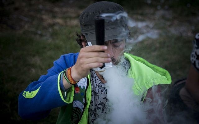 Israelis gather at the Rose Garden in front of the Knesset to mark the international '4:20' marijuana smoking day, in a demonstration to push legalizing the drug, in Jerusalem, on April 20, 2017. (Yonatan Sindel/Flash90) Israelis gather at the Rose Garden in front of the Knesset to mark the international '4:20' marijuana smoking day, in a demonstration to push legalizing the drug, in Jerusalem, on April 20, 2017. (Yonatan Sindel/Flash90)