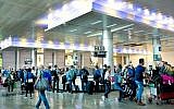 Illustrative: Travelers in the arrival hall of Ben Gurion Airport, near Tel Aviv, on April 11, 2018. (Moshe Shai/FLASH90)