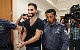 Natanel Sandrusi, accused of running over an 11-year-old child, severely wounding him, and then fleeing the scene, arrives for a hearing at the Jerusalem District Court, on June 3, 2019. (Noam Revkin Fenton/Flash90)