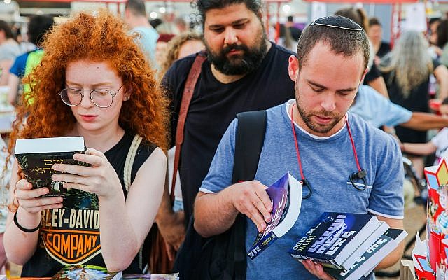 Looking for a book to buy at the 2019 Hebrew Book Week in Tel Aviv's Rabin Square.(Courtesy Flash 90) Looking for a book to buy at the 2019 Hebrew Book Week in Tel Aviv's Rabin Square.(Courtesy Flash 90)