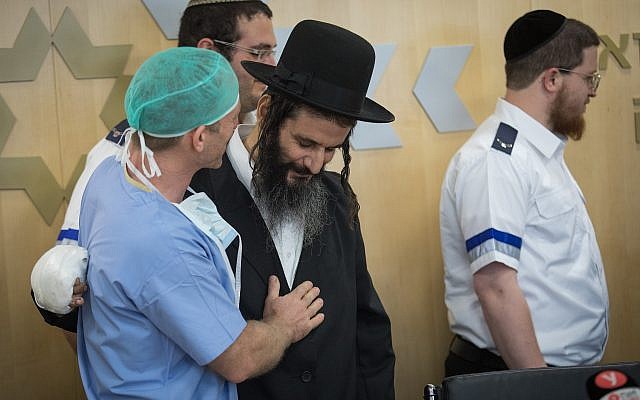 Gabriel Lavi, center, is seen with his doctors and paramedics who helped him as he gives a statement to the press before his release at Shaare Zedek Hospital in Jerusalem, on June 12, 2019. (Hadas Parush/Flash90) Gabriel Lavi, center, is seen with his doctors and paramedics who helped him as he gives a statement to the press before his release at Shaare Zedek Hospital in Jerusalem, on June 12, 2019. (Hadas Parush/Flash90)