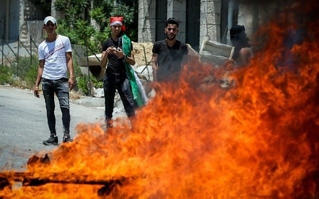 Palestinian demonstrators clash with Israeli border police during a protest against US President Donald Trump's economic plan, in the West Bank village of Halhoul, near Hebron, on June 24, 2019. (Wisam Hashlamoun/Flash90) Palestinian demonstrators clash with Israeli border police during a protest against US President Donald Trump's economic plan, in the West Bank village of Halhoul, near Hebron, on June 24, 2019. (Wisam Hashlamoun/Flash90)