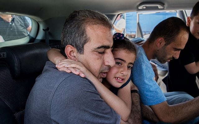 Mahmoud Qadusa (R) hugs his daughter after being released from prison on June 25, 2019. (Yonatan Sindel/Flash90) Mahmoud Qadusa (R) hugs his daughter after being released from prison on June 25, 2019. (Yonatan Sindel/Flash90)