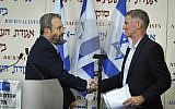 Former prime minister Ehud Barak (L) shakes hands with Yair Golan after announcing the formation of a new party at Tel Aviv's Beit Sokolov on June 26, 2019. (Jacob Magid/Times of Israel)