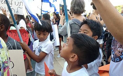 Illustrative: Two Filipino boys at the protest against deportations in Tel Aviv on June 24, 2019.  (Melanie Lidman/Times of Israel)