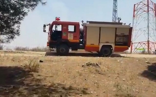 Screen capture from video of firefighters at the scene of a fire in the Kissufim Forest, June 10, 2019. (Twitter) Screen capture from video of firefighters at the scene of a fire in the Kissufim Forest, June 10, 2019. (Twitter)