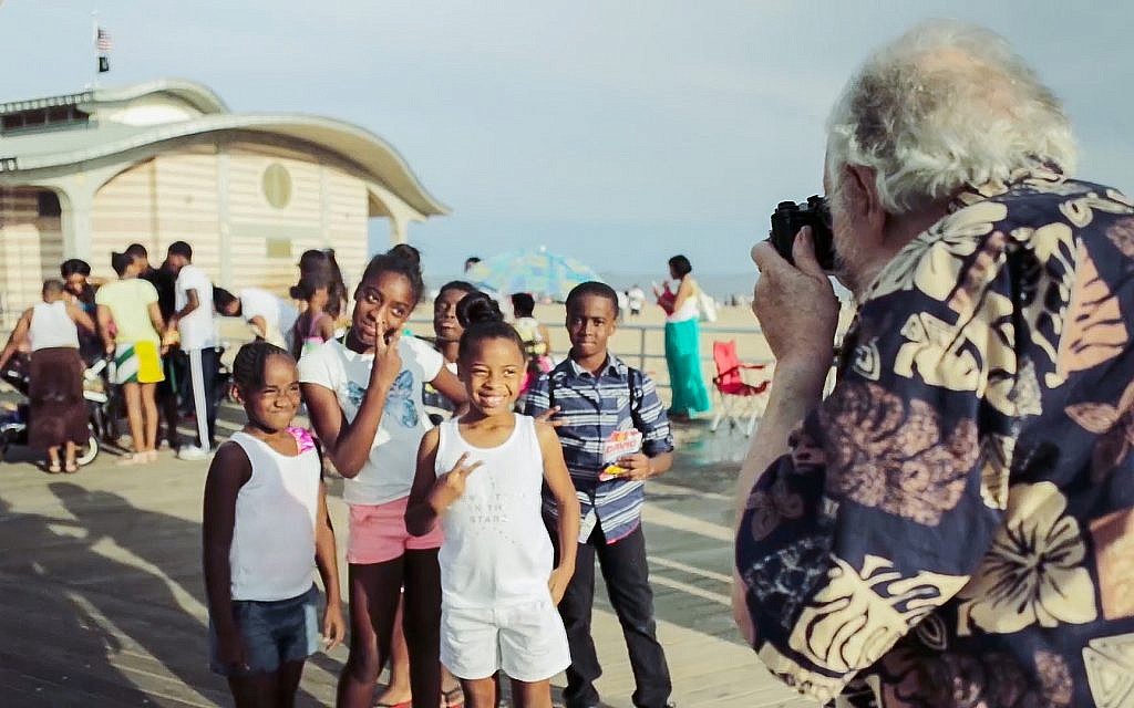 Harold Feinstein photographs a group of children at Coney Island in this still from the documentary 'Last Stop Coney Island.' (Courtesy)