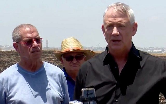 Blue and White party leader Benny Gantz (R) speaks to reporters at a burnt field in southern Israel on June 28, 2019. (Screen capture: Twitter) Blue and White party leader Benny Gantz (R) speaks to reporters at a burnt field in southern Israel on June 28, 2019. (Screen capture: Twitter)