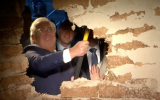 US Ambassador David Friedman breaks down a specially built wall in front of the Pilgrimage Road, at a ceremony in the East Jerusalem neighborhood of Silwan, on June 30, 2019. (Facebook/Screen capture)