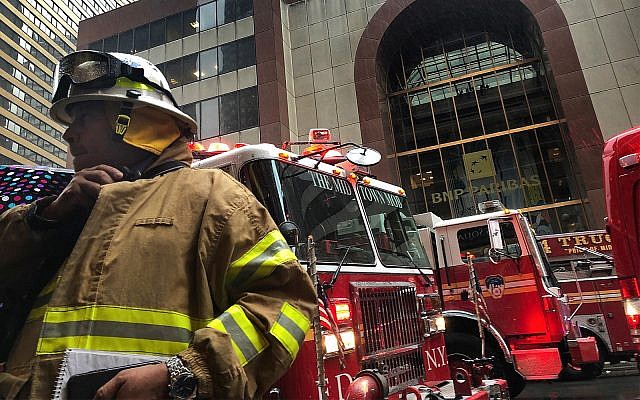 A New York City firefighter responds to the scene where a helicopter crash-landed on the roof of a midtown Manhattan skyscraper, June 10, 2019, in New York. (AP Photo/Mark Lennihan) A New York City firefighter responds to the scene where a helicopter crash-landed on the roof of a midtown Manhattan skyscraper, June 10, 2019, in New York. (AP Photo/Mark Lennihan)