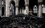A worker stands on scaffolding during preliminary restoration work inside the Notre Dame Cathedral, May 15, 2019. (Philippe Lopez/Pool via AP)