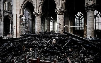 A worker stands on scaffolding during preliminary restoration work inside the Notre Dame Cathedral, May 15, 2019. (Philippe Lopez/Pool via AP)