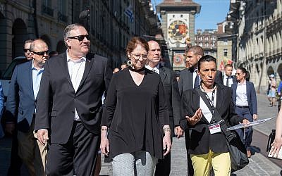 US Secretary of State Mike Pompeo, front left, and his wife Suzan, front center, listen to a tour guide during a sightseeing walk as part of Pompeo's visit in Bern, Switzerland, June 1, 2019. (Peter Klaunzer/Keystone via AP)