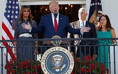 US President Donald Trump, with first lady Melania Trump, left, and Vice President Mike Pence, right, and his wife Karen, speaks from the Truman Balcony of the White House during the annual Congressional Picnic on the South Lawn June 21, 2019. (AP Photo/Jacquelyn Martin)