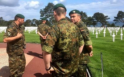 German soldiers from the Panzergrenadier battalion 909 from Marienberg, Saxony, visit the Normandy American Cemetery in Colleville-sur-Mer, Normandy, France, Monday, June 3, 2019, ahead of the 75th anniversary commemorations of D-Day. Allied forces landing in Normandy 75-years ago faced German soldiers, but over the decades, Germans' attitudes toward the war have evolved from a sense of defeat to something far more complex. (AP Photo/Raf Casert)
