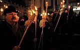 Ukrainians hold burning torches as they gather in Kiev, Ukraine, March 5, 2010, to mark the 60th anniversary of the death of Roman Shukhevych, a Ukrainian politician, military leader and Nazi collaborator. (AP Photo/Sergei Chuzavkov)