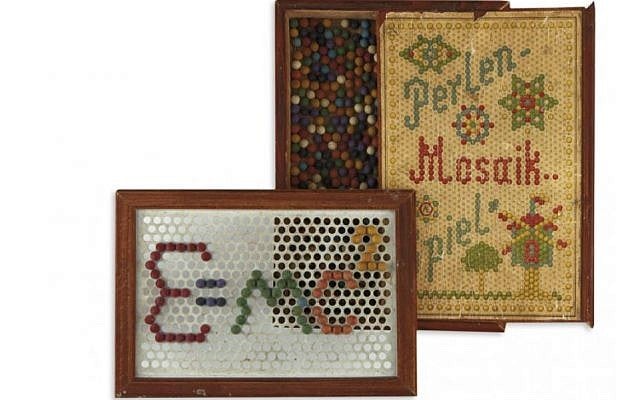A childhood toy of physicist Albert Einstein containing small colored wooden balls used to create designs on the punch-hole frame. The box reads, 'Perlen-Mosaik-Spiel,' or 'pearl mosaic game.' The toy is up for sale by New York auctioneers Kestenbaum & Company, June 2019. (Kestenbaum & Company website) A childhood toy of physicist Albert Einstein containing small colored wooden balls used to create designs on the punch-hole frame. The box reads, 'Perlen-Mosaik-Spiel,' or 'pearl mosaic game.' The toy is up for sale by New York auctioneers Kestenbaum & Company, June 2019. (Kestenbaum & Company website)