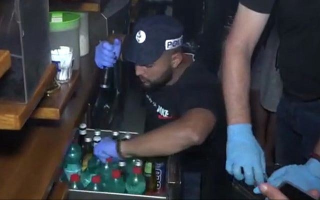 Police raid a gay sauna in Tel Aviv on June 8, 2019 (Screen grab via Channel 12)