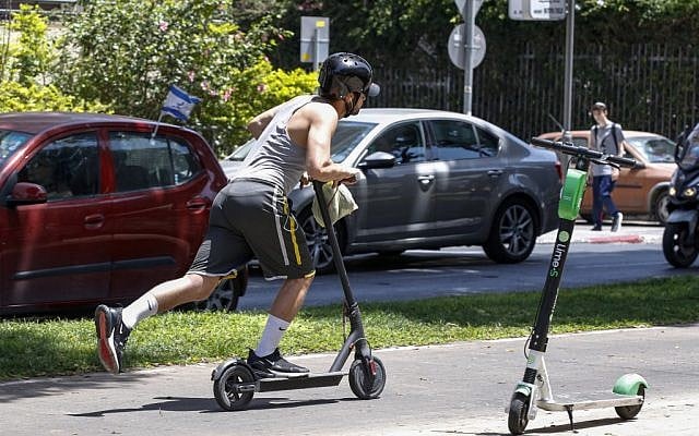 A man rides an electric scooter in the streets of Tel Aviv on May 30, 2019. (Jack Guez/AFP)